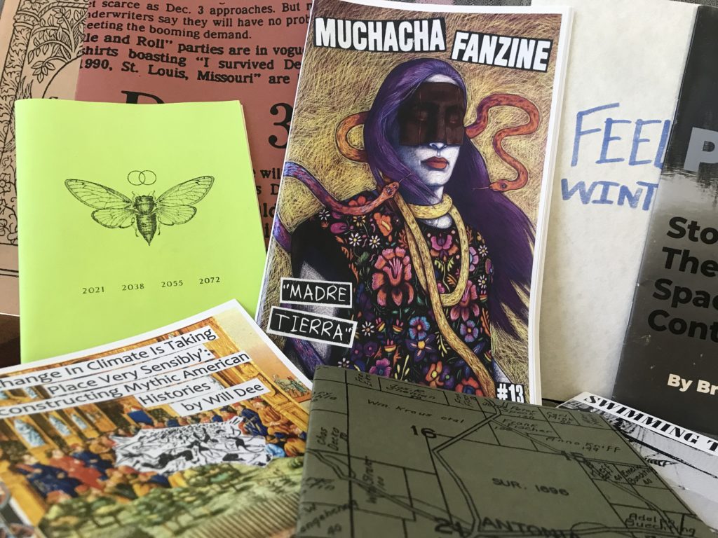 A colorful display of zines, with their covers facing the reader